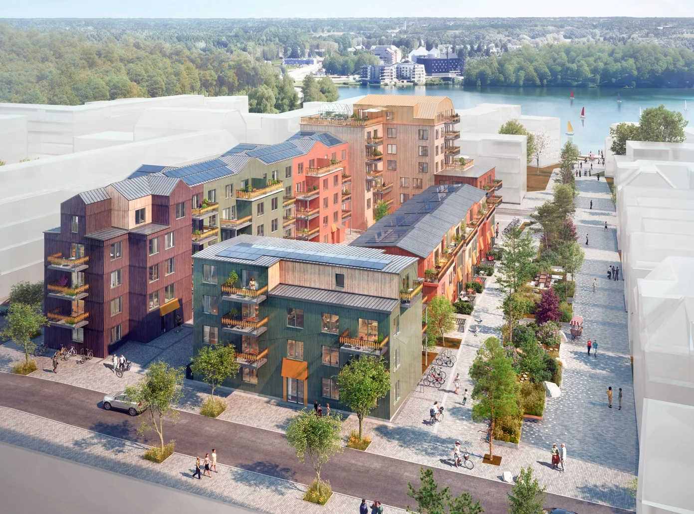 VYN vid Väsjö Torg från luften — träfasader i varma kulörer, solceller på taken och Väsjön bakom.